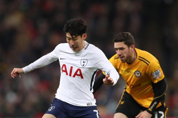 Tottenham Hotspur's Son Heung-Min and Newport County's Ben Tozer (right) battle for the ball during the Emirates FA Cup, fourth round replay match at Wembley Stadium, London. PRESS ASSOCIATION Photo. Picture date: Wednesday February 7, 2018. See