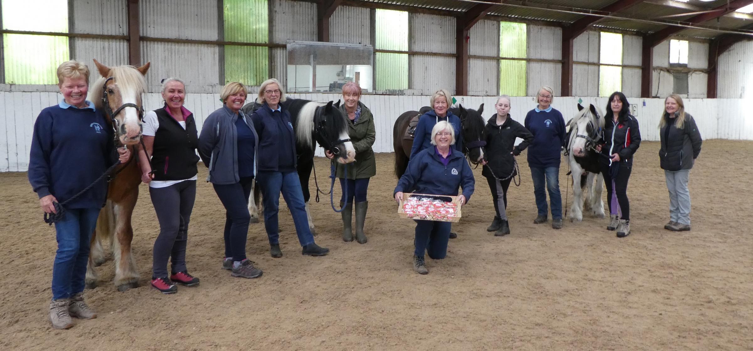 Some of the Clwyd Special Riding Centre volunteers receiving their thank you biscuits during Volunteers Week.