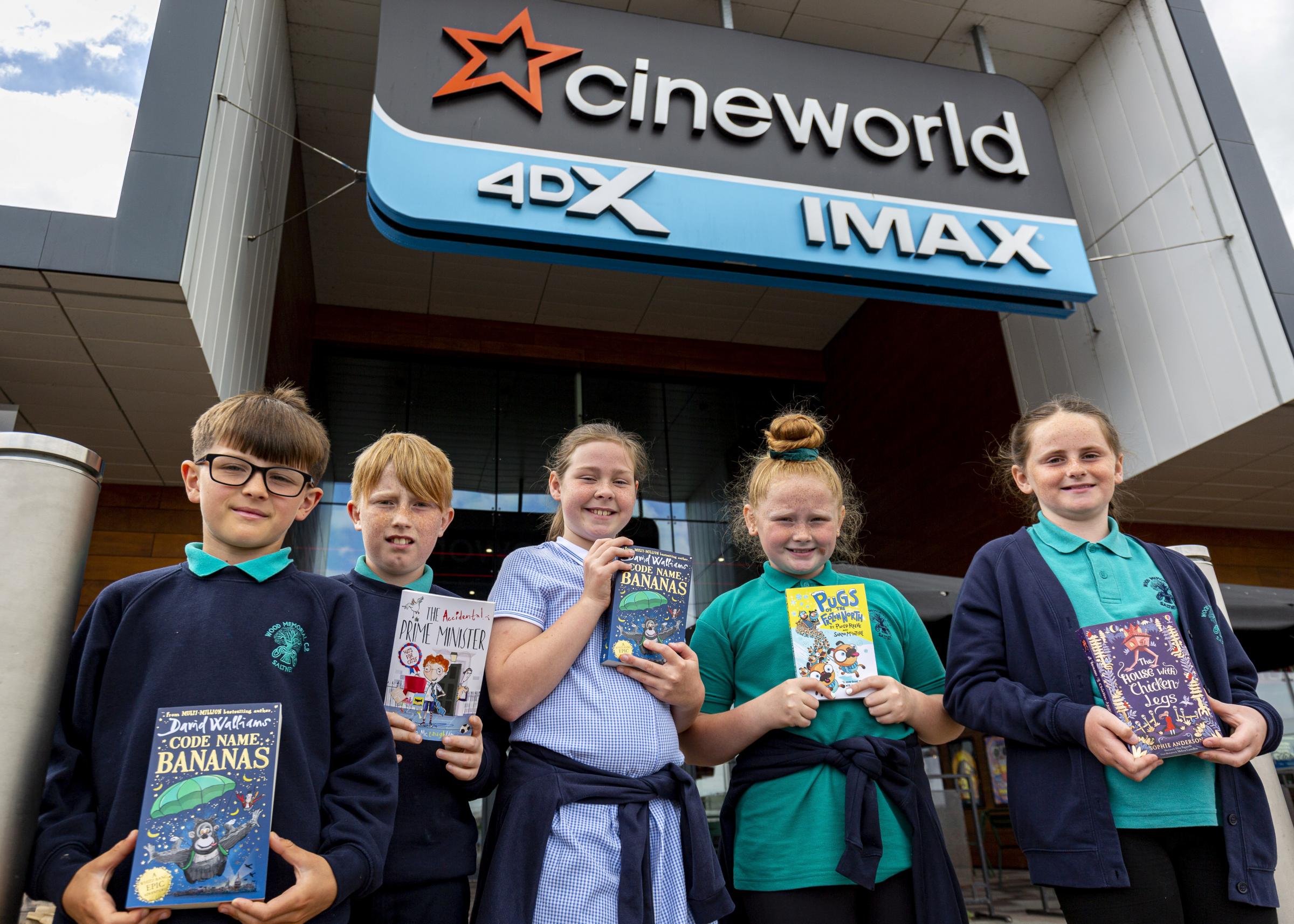 Students holding their new books from a Young Reader’s Programme event, outside Cineworld at Broughton Shopping Park.
