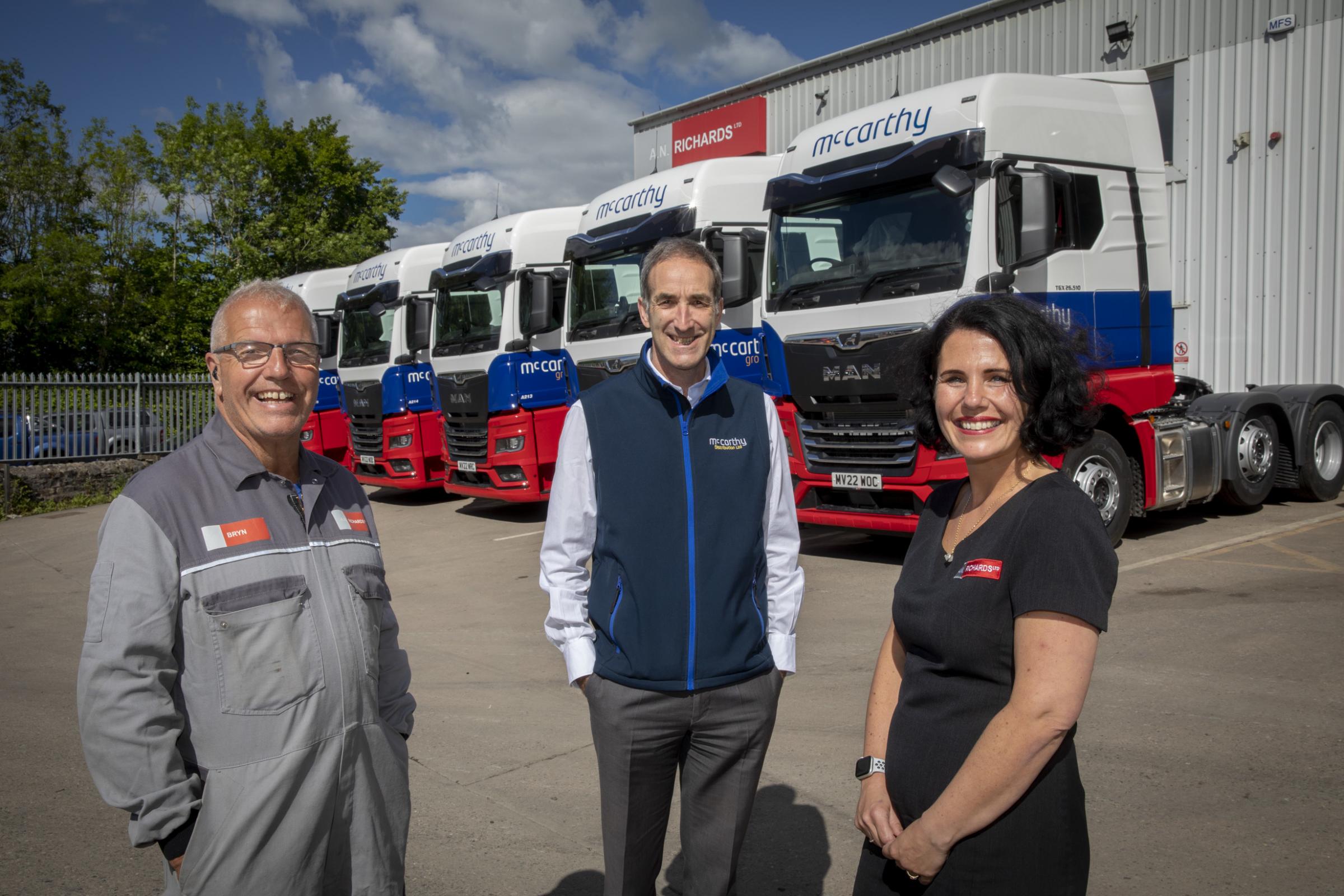 McCarthy Haulage Wrexham take delivery of the 100th truck from AN Richards: Mike McCarthy (centre) with Bryn Richards managing director of AN Richards and Johanna Cooke company secretary. Photo: Mandy Jones