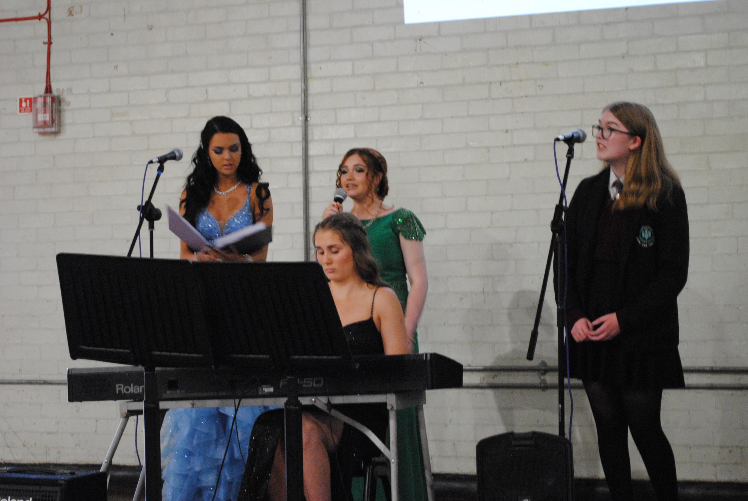 Olivia Bateman, Stevie Duncan and Adele Crimes perform ‘Hallelujah’ accompanied by Megan Pearson on the keyboard.