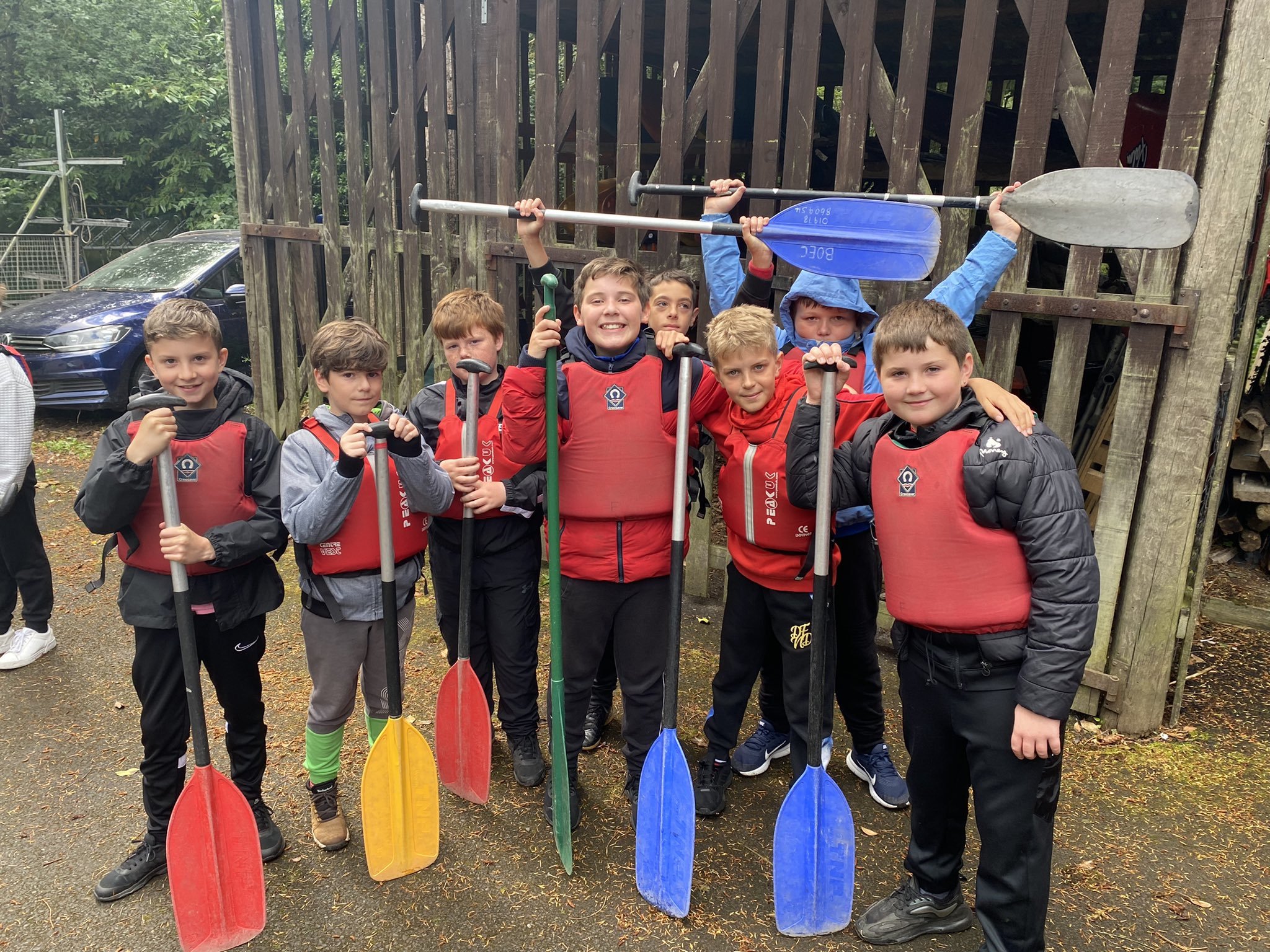 A group of boys are kitted out ready for their canoeing activity.