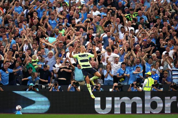 Erling Haaland celebrates after scoring his first goals in the Premier League on his league debut for Manchester City