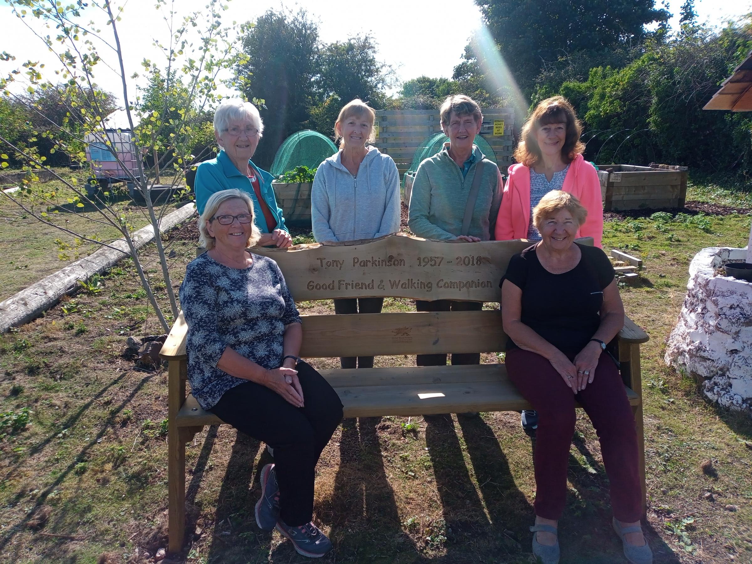 Sister Pearl Pilkington and members of Walkabout Flintshire with the memorial bench at Bagillt Community Garden, in memory of Tony Parkinson.
