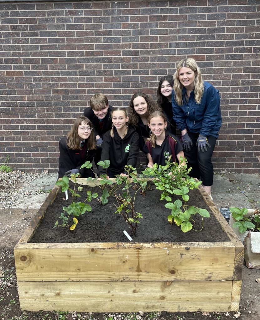 Charlotte Harding, Owen Ashbrook, Sophie Hoxby Worrall, Zara Morait, Evie Ellis, Megan England and Miss Williams with a planted up raised bed.