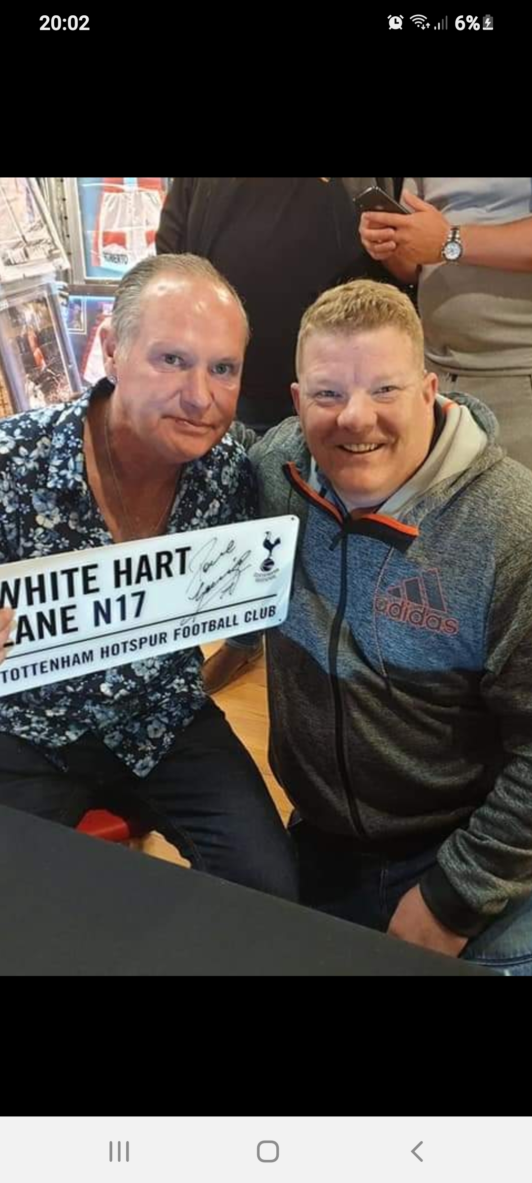 Paul Gascoigne signs a White Heart Lane plaque for Bradley Davies.