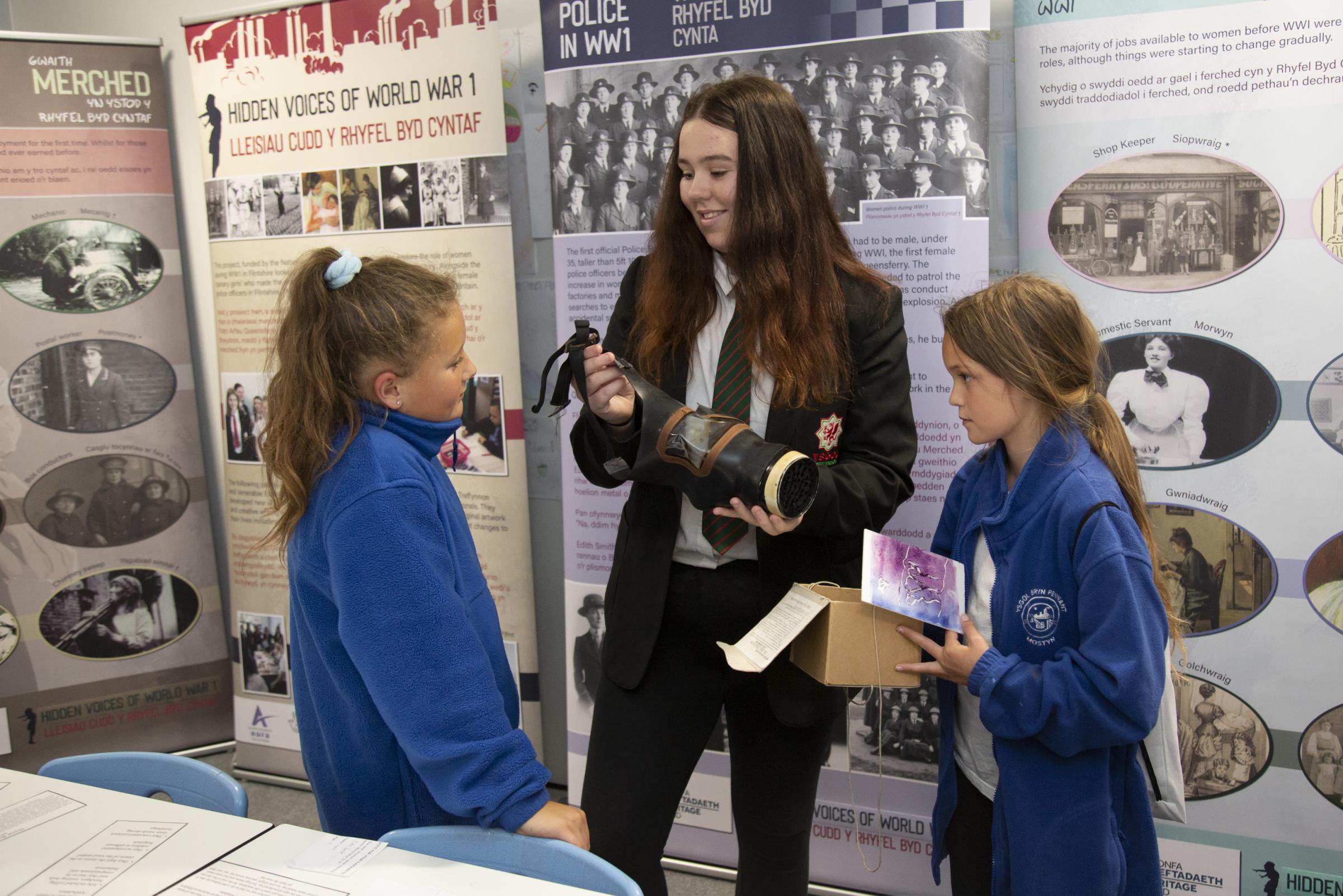 MaisieJones, Year 11, explains some of the artefacts to children in the history department.