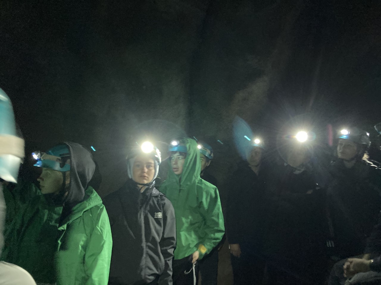 Flint High School students brave the dark to explore the caves.