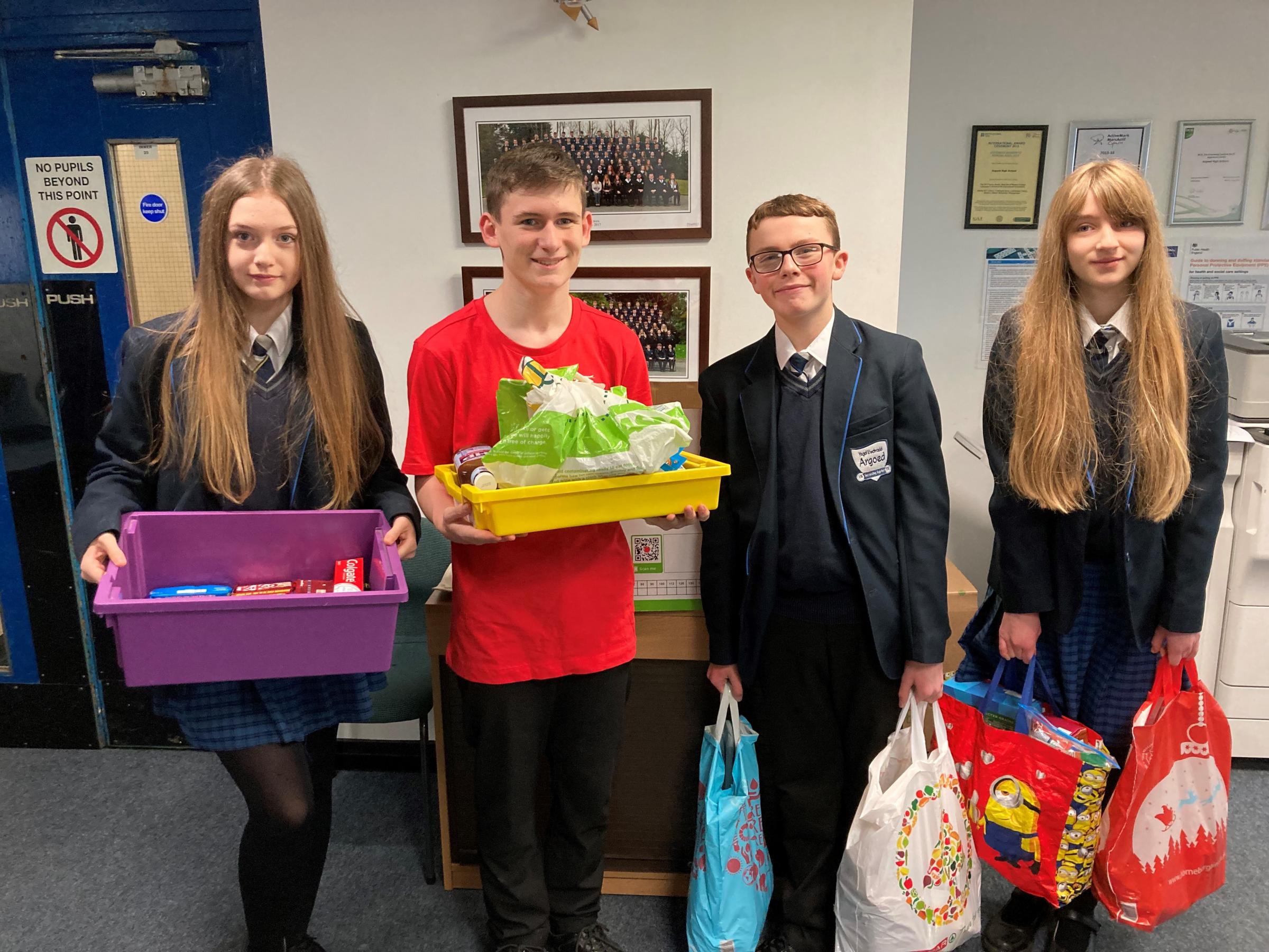 Sophie Forster, Finley Holland, Rhys Parry and Lauren Perdue with some of the donations that have come into Argoed High School.