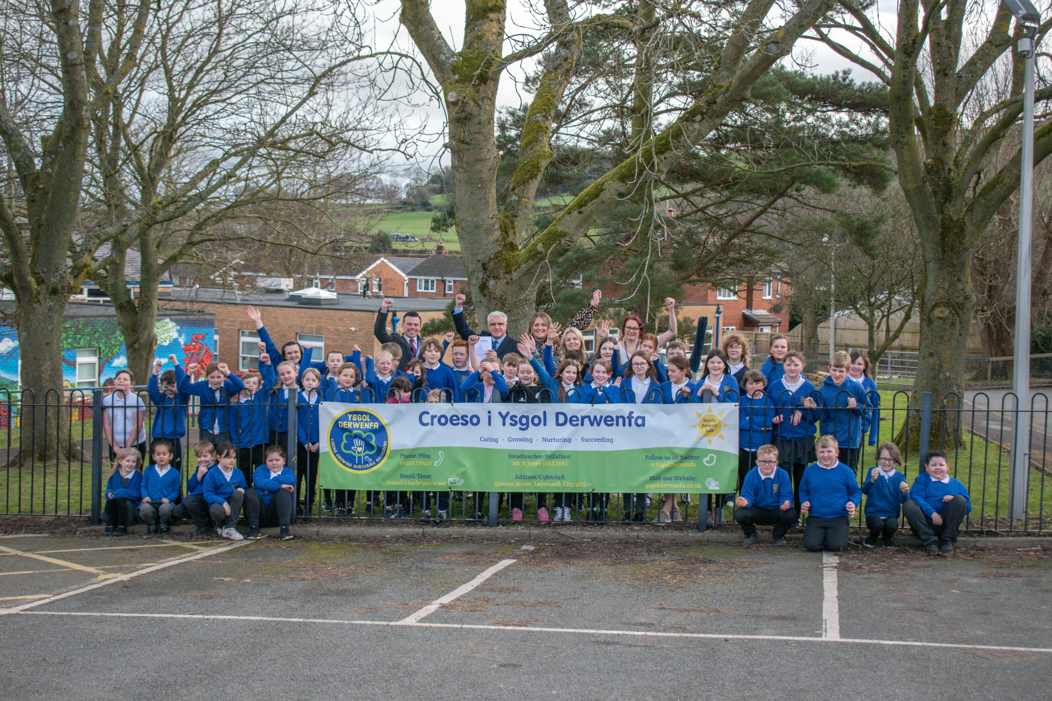 Pupils and staff at Ysgol Derwenfa, in Leeswood, celebrate a positive Estyn report.