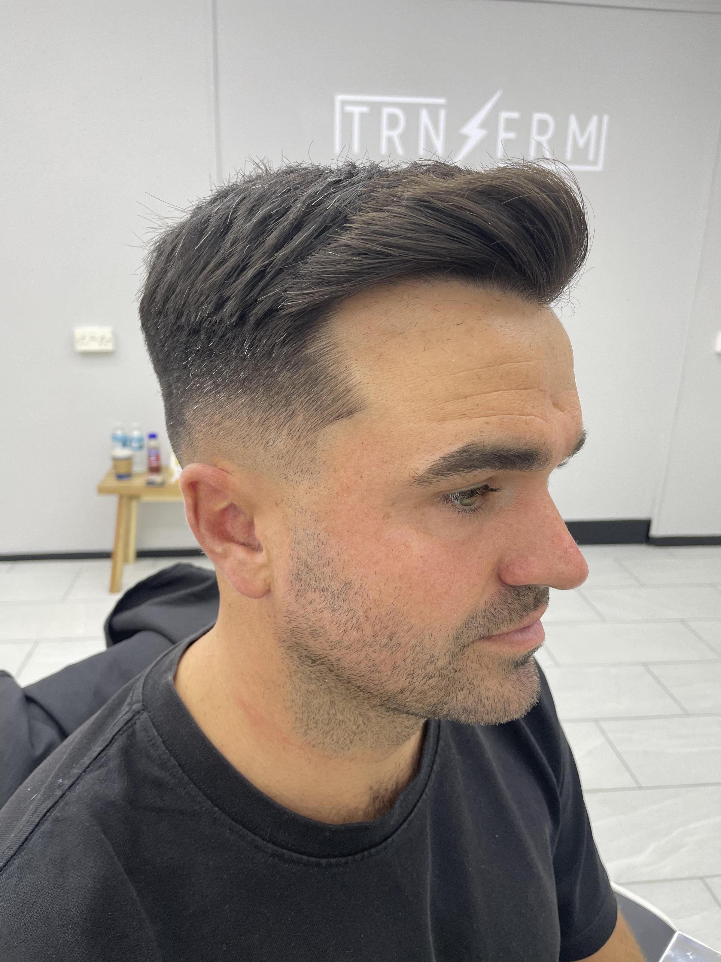Skin fade with modern style quiff, done by Jev.
