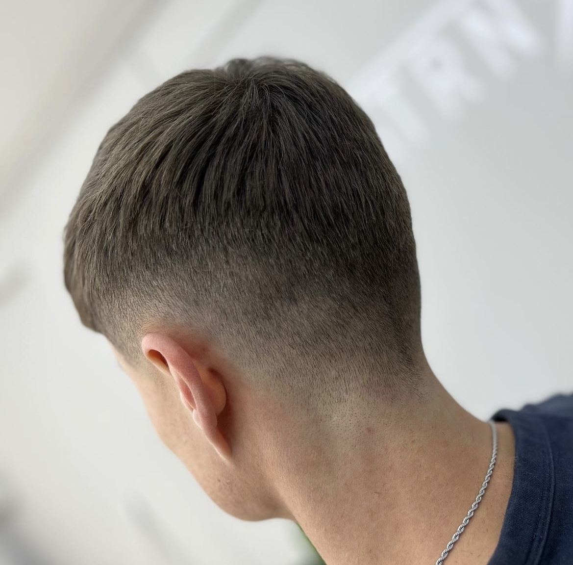 Classic short back and sides with taper, graduated scissor work on top, done by Ned.