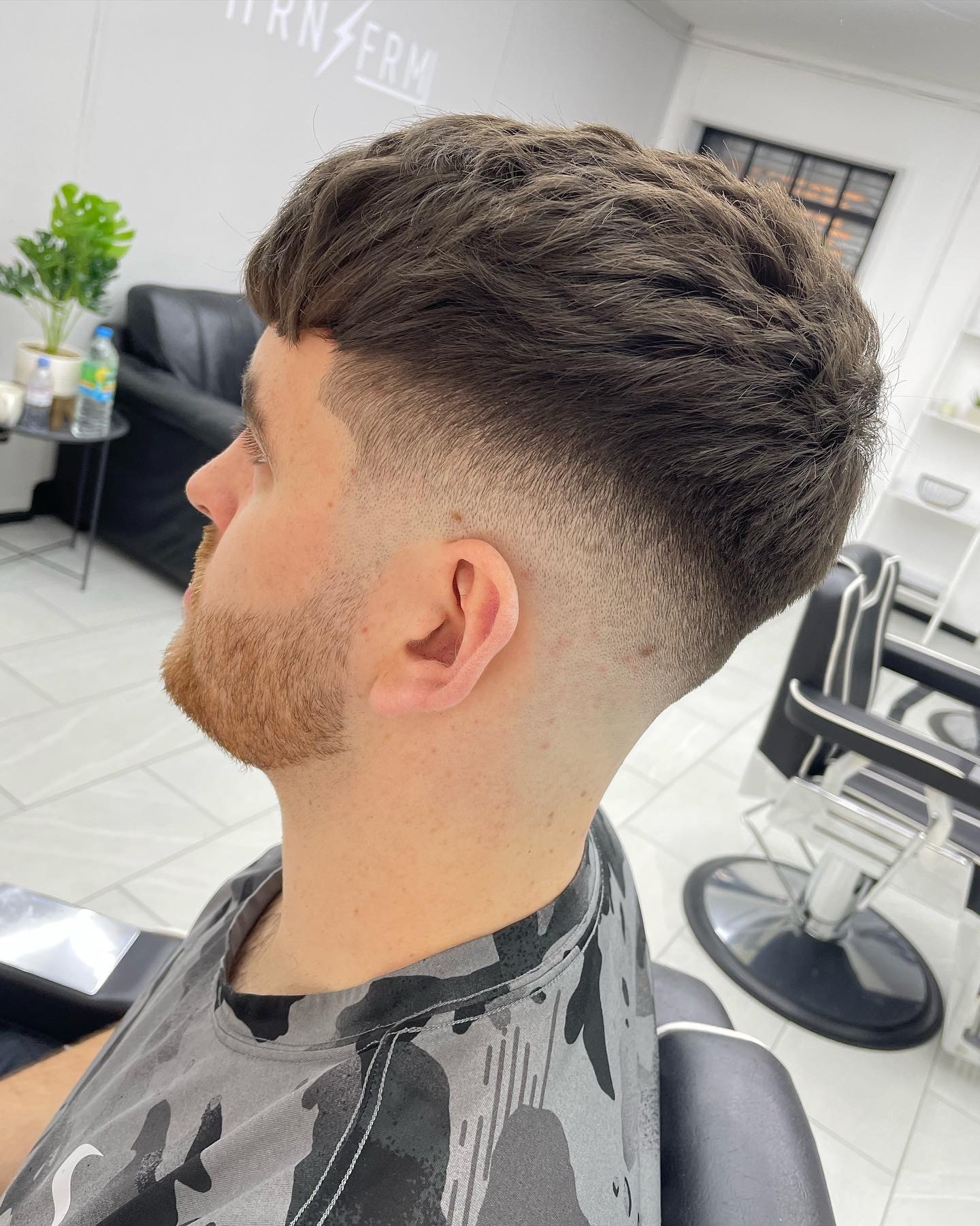 Skin fade with textured top, done by Jev.