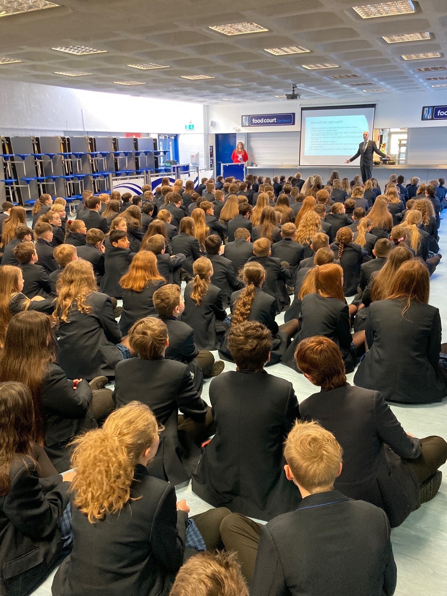 Assistant headteacher Mike Lofts leads a special assembly about how the new rewards system will work in conjunction with the book vending machine.