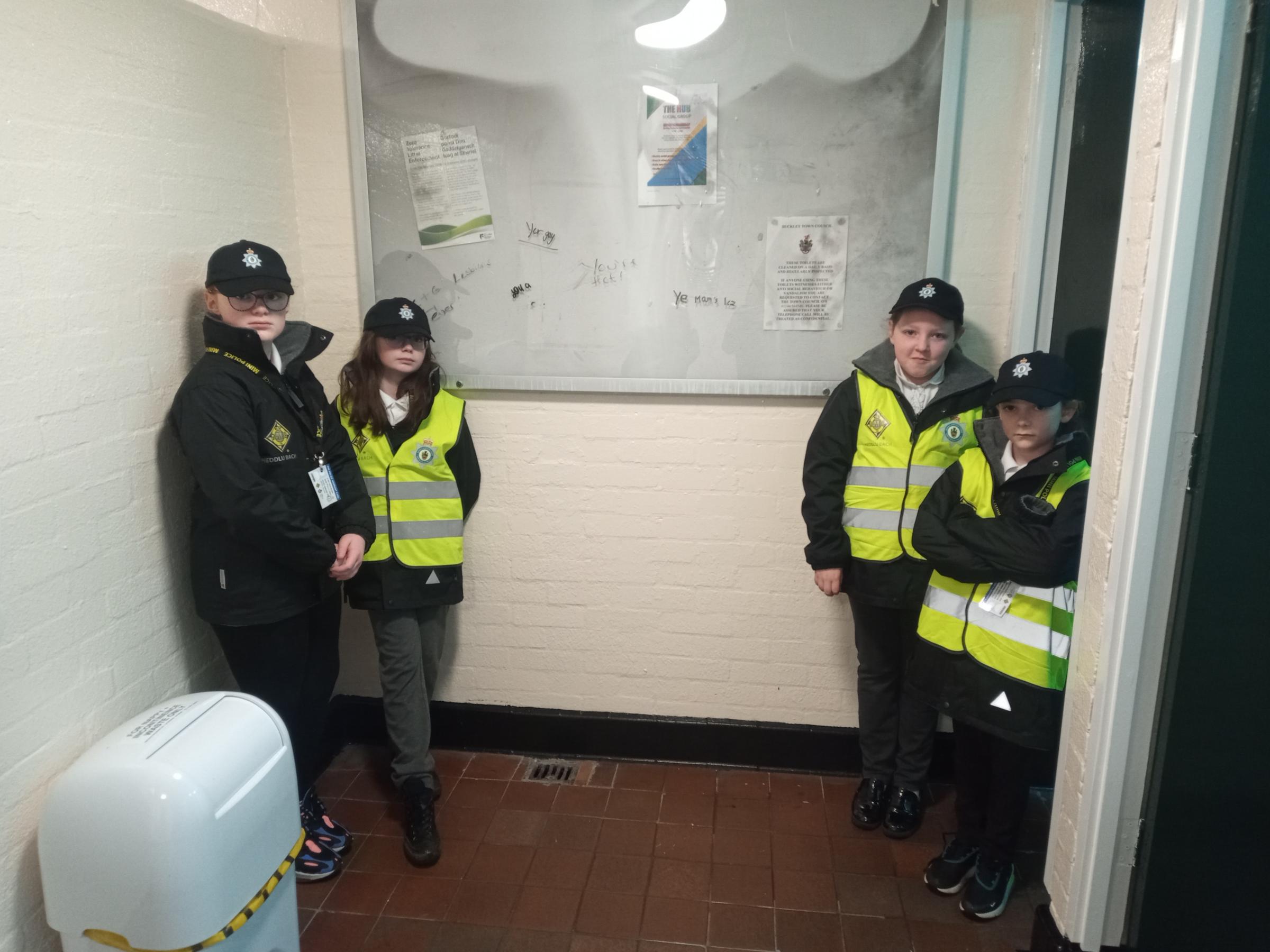 Westwood CP School Mini Police check out some of the damage to the public toilets in Buckley.