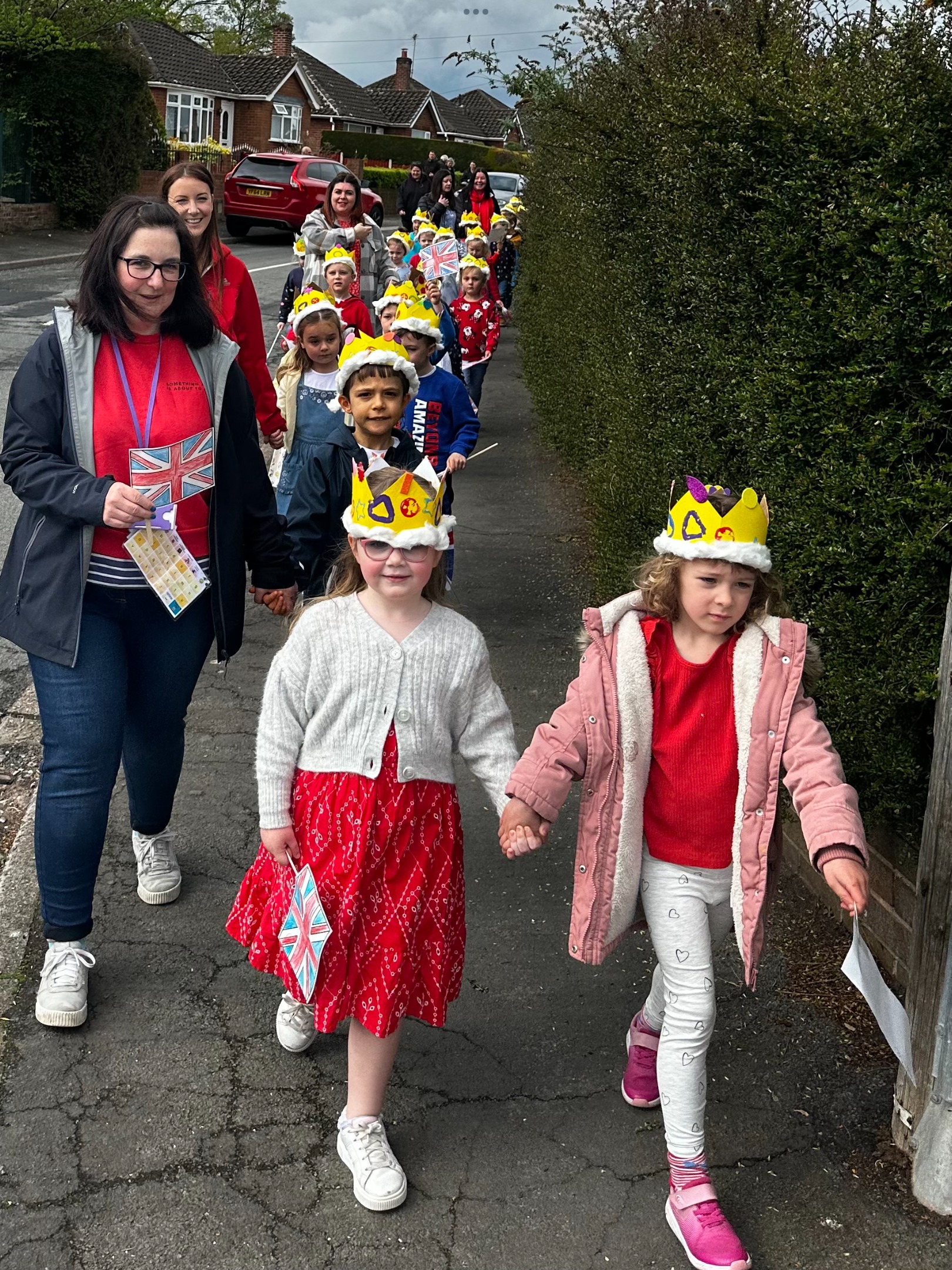 Ysgol Mynydd Isa pupils taking part in a Coronation parade.