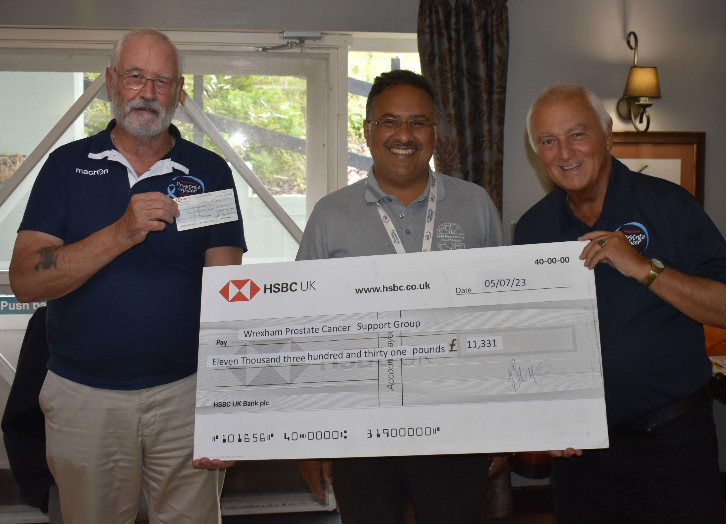 Club members Frank Maddocks and Phil Jones present Wrexham Maelor Hospital urologist Prof Iqbal Shergill with the cheque.