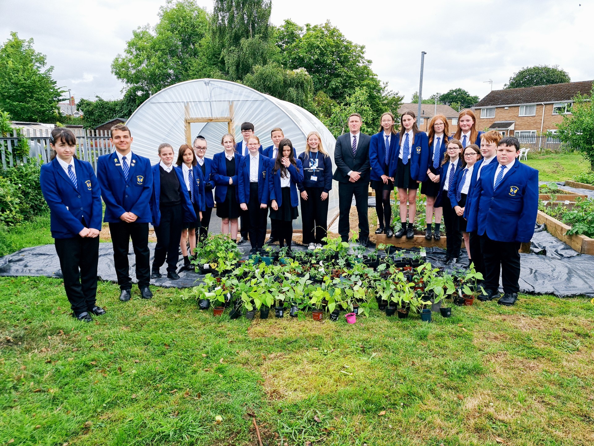  Ysgol Rhosnesni Nurture gardening team with headmaster Andy Brant and Chloe from the Nightingale House Hospice fundraising team, along with all the donated plants.
