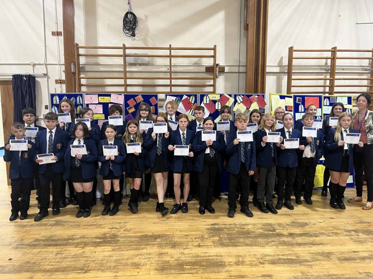 New Year 7 students at Ysgol Rhiwabon, with their SWAN certificates.