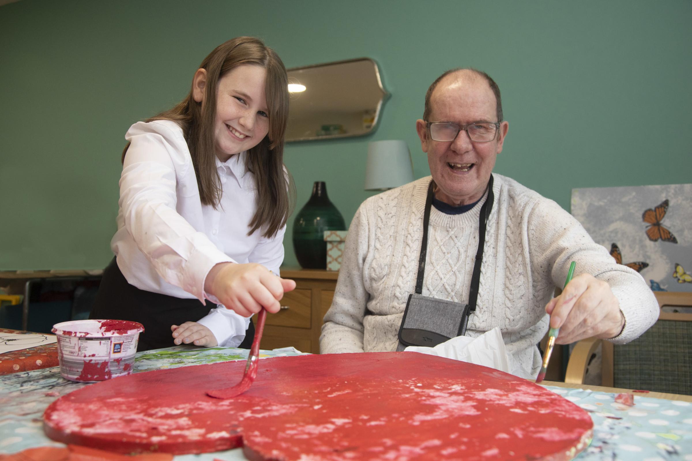 Gwersyllt pupil Olivia painting with resident Tony Ithell. Picture: Mandy Jones