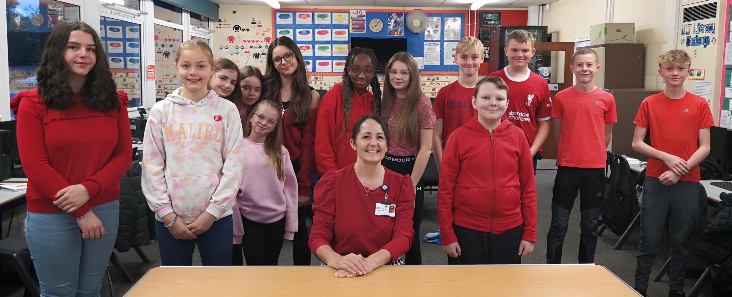 A Year 8 form group wears red for the Wear Red Day.