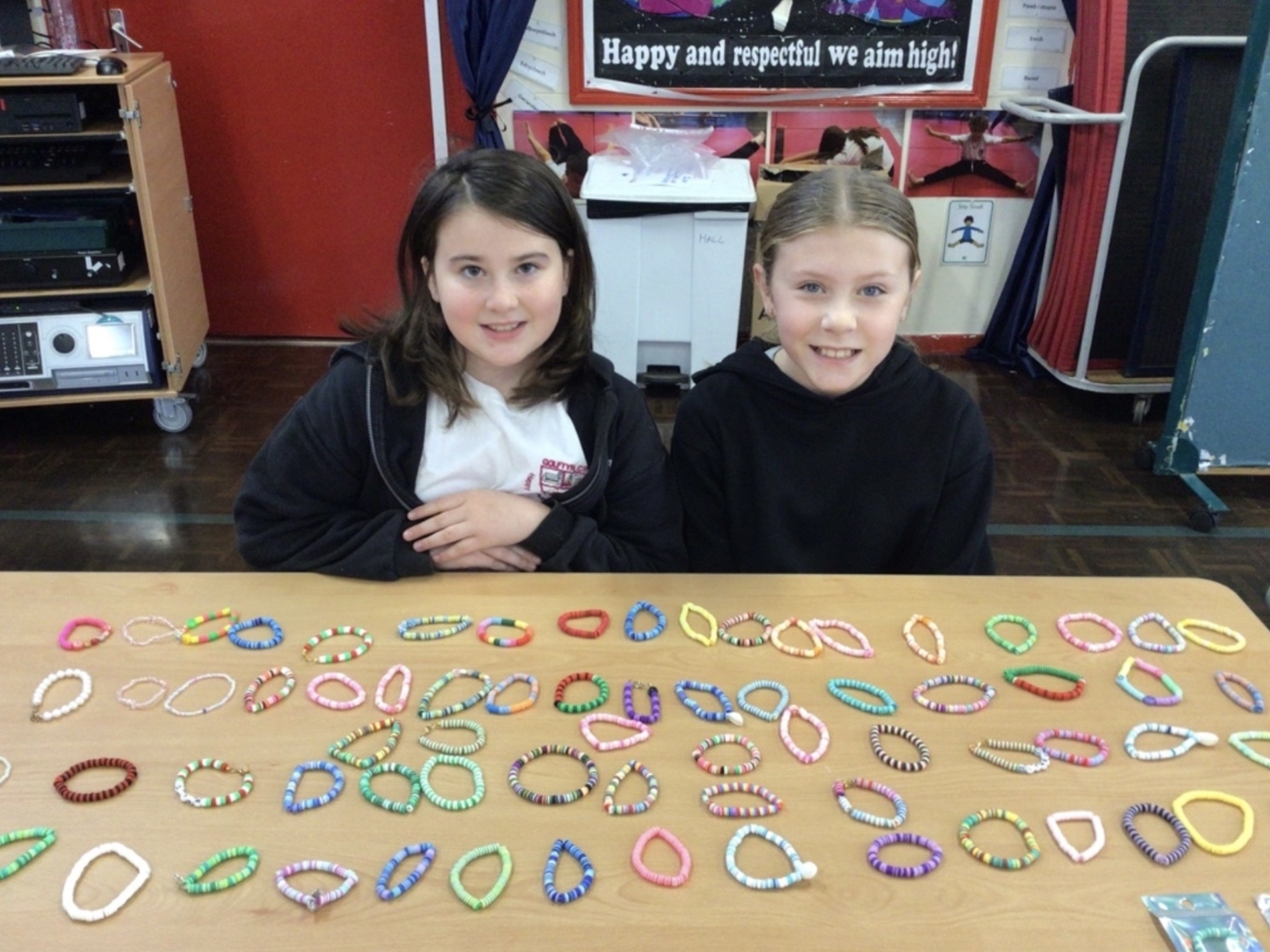Ava and Jasmine with some of the bracelets the sold for the Red Cross.