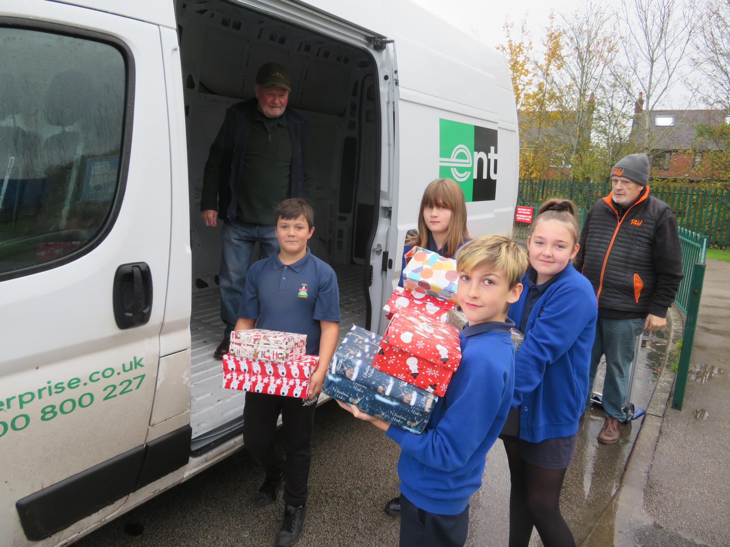Pupils helping to load the shoeboxes as part of the Teams4U appeal.