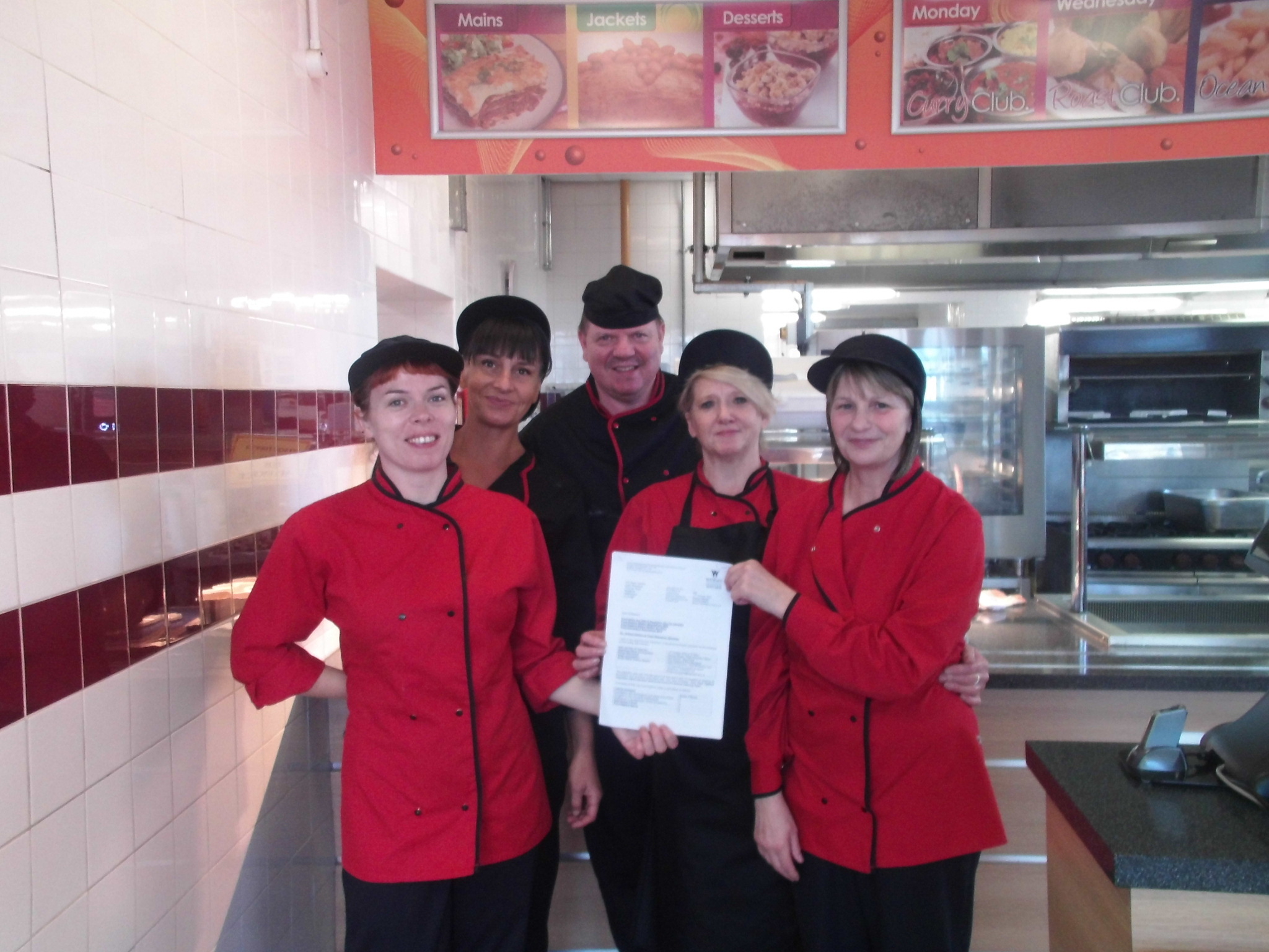 Ysgol Rhiwabon head cook Mark Davies and his team with the official letter and certificates for their top hygiene rating.