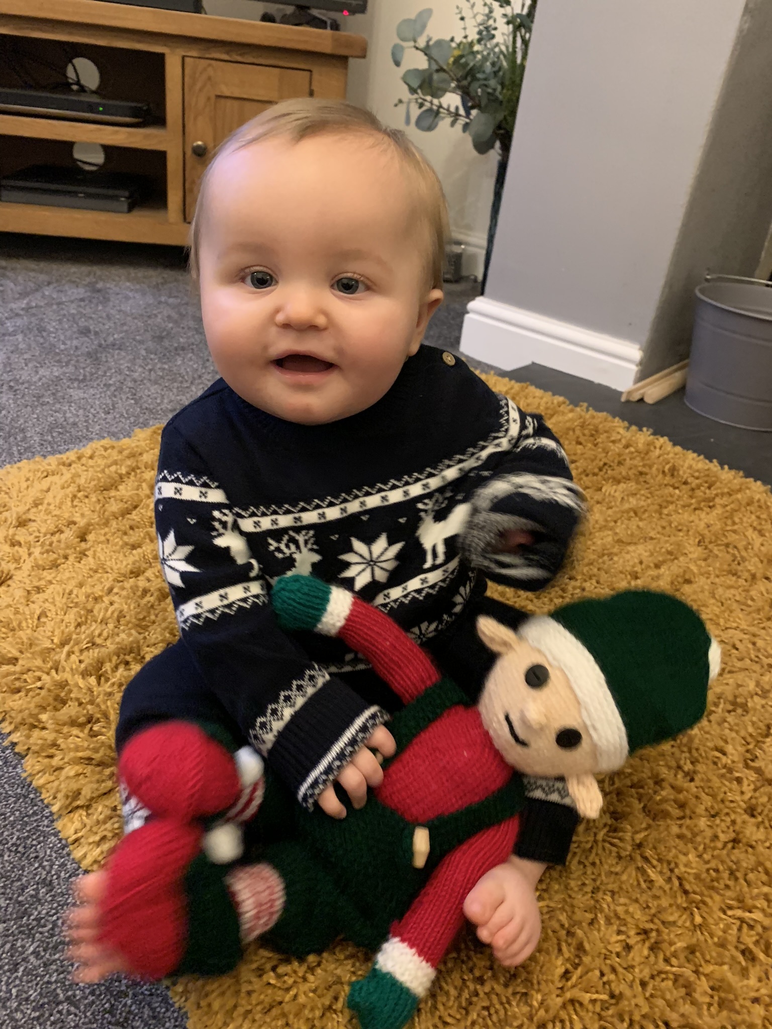 Sam Griffiths, from Rhostyllen: Arthur Llewellyn Griffiths at 10 months sitting and holding his Christmas elf that he had from the Christmas fate in Rhostyllen Parrish hall, made by Janet Williams.