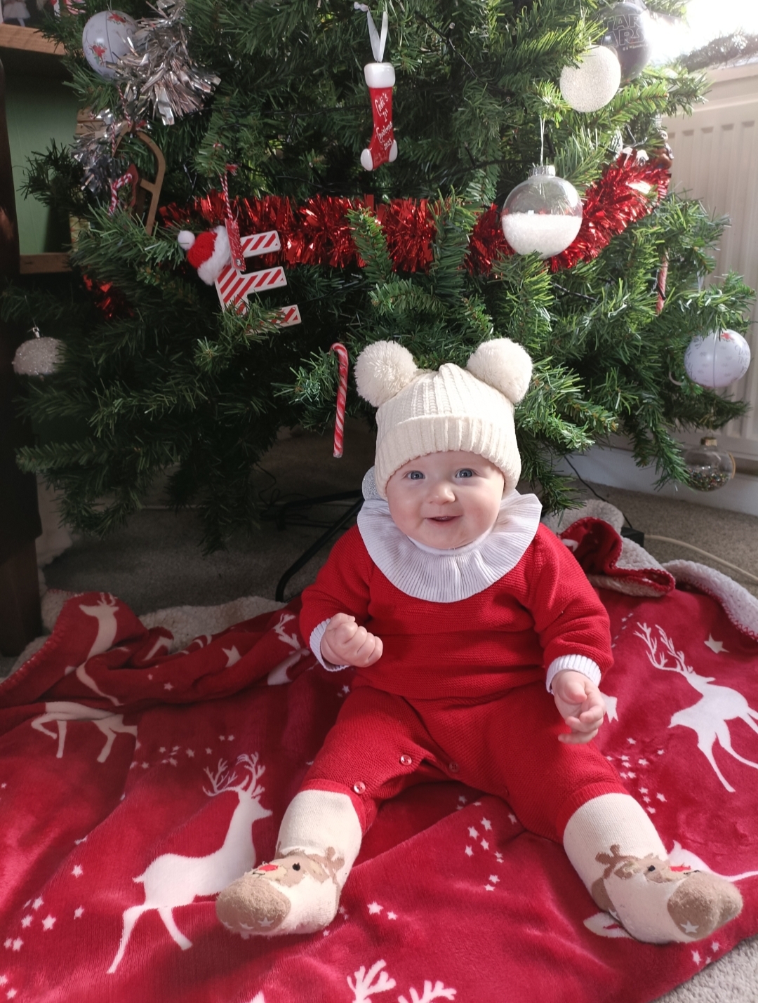 Eleri Llywarch, from Rhosesmor: Six-month-old Cadi Grace Amelia Parry, at home under her first Christmas tree.