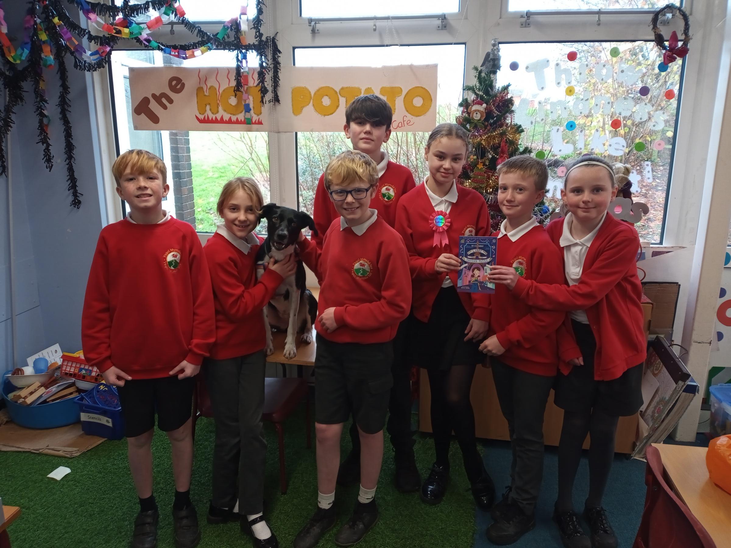 The group of Ysgol Mynydd Isa pupils with visiting therapy dog Penny.