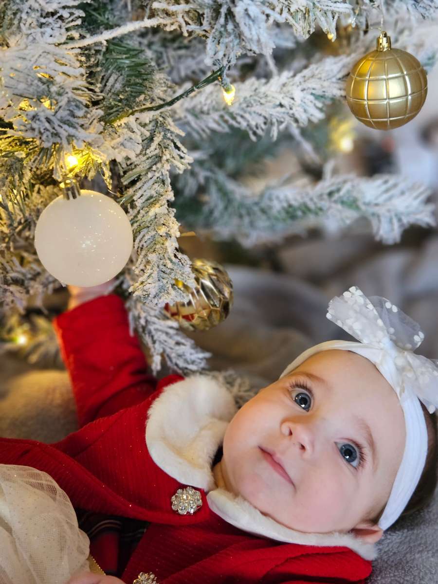 Caitlyn and Joshua Jones, from Hope: Seven-month-old Holly-Grace playing with baubles on their first Christmas tree.