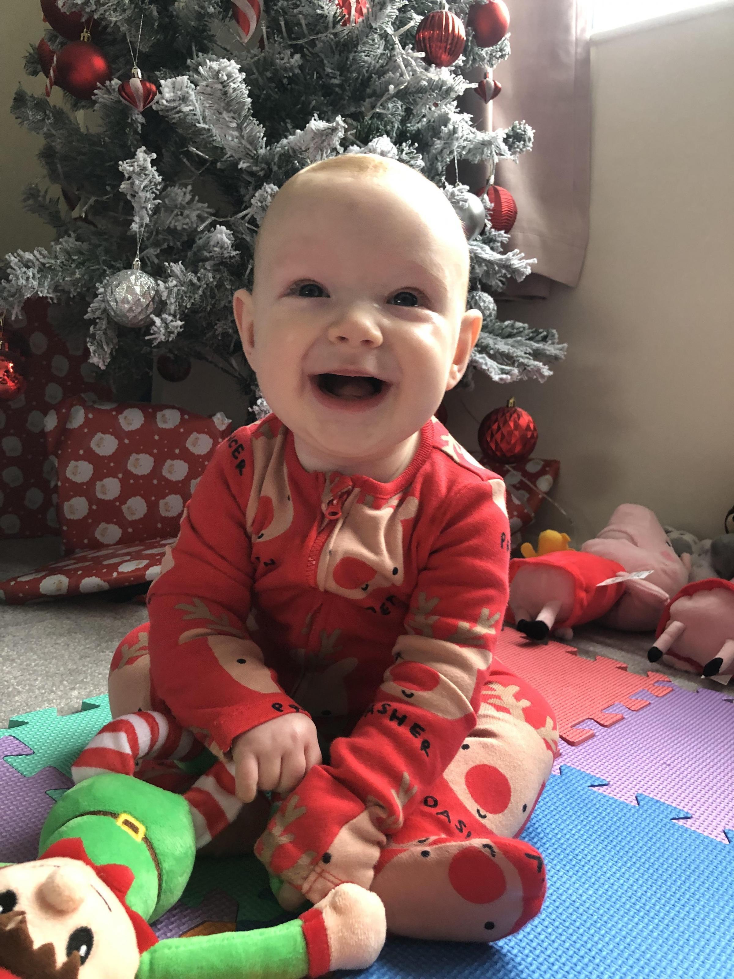 Holly Grindley, from Coedpoeth in Wrexham: Six-month-old River Griffiths playing with his toy elf under the Christmas tree.
