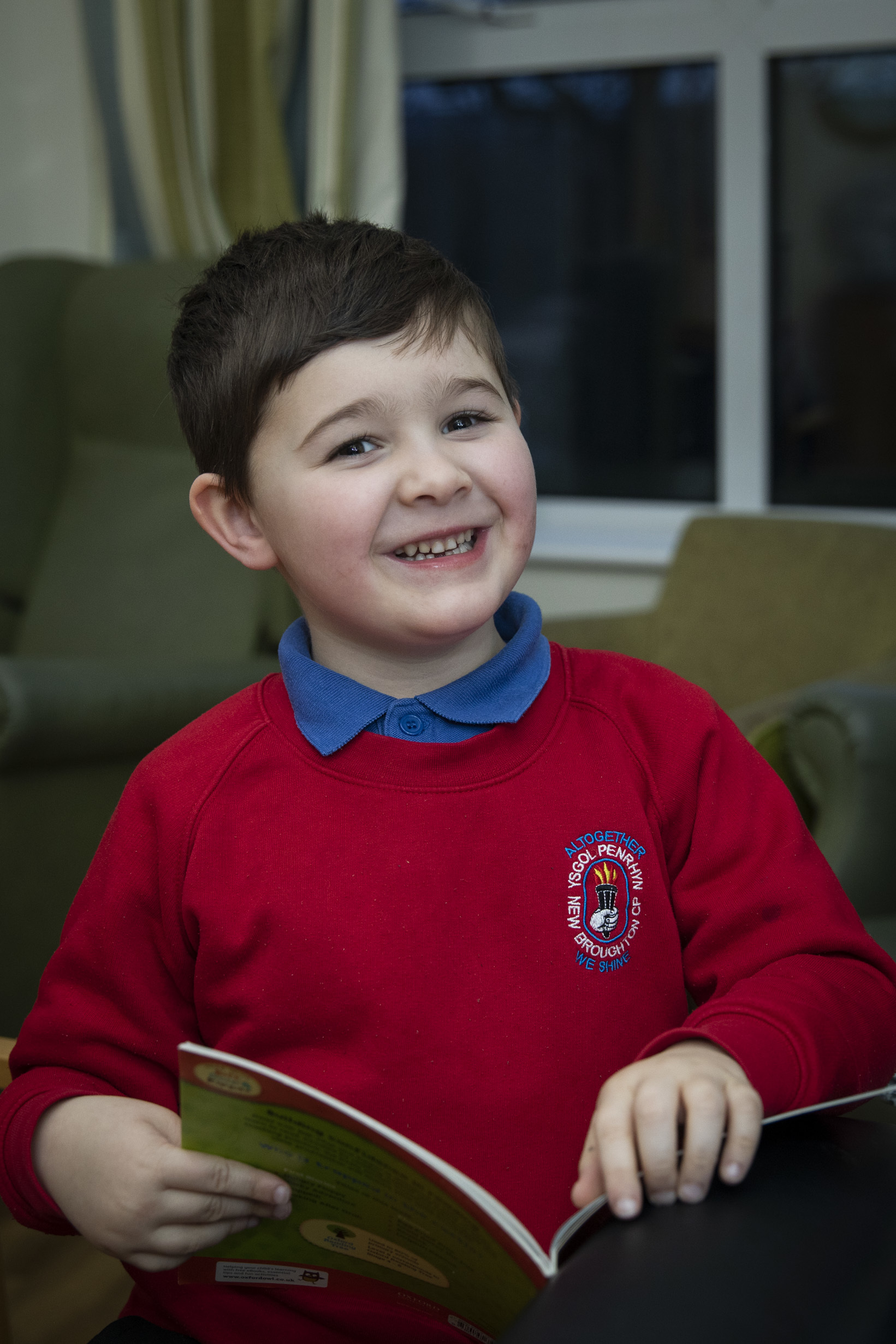 Harri Shone, who visits Pendine Park after school to read stories residents. Photo: Mandy Jones