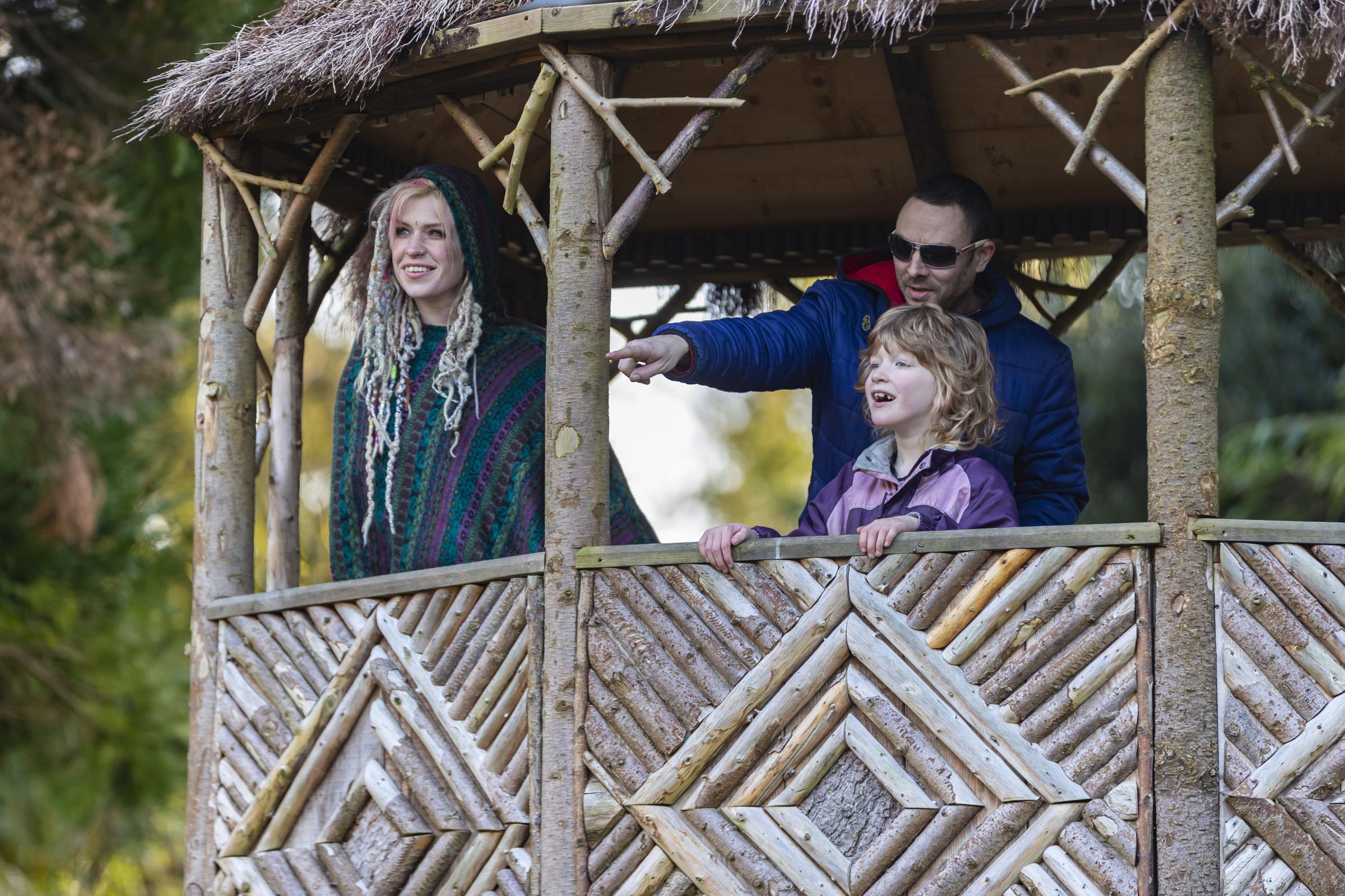 Visitors exploring the Bog Garden from the thatched hut at Penrhyn Castle and Garden, Gwynedd. Photo: National Trust Images-Paul Harris