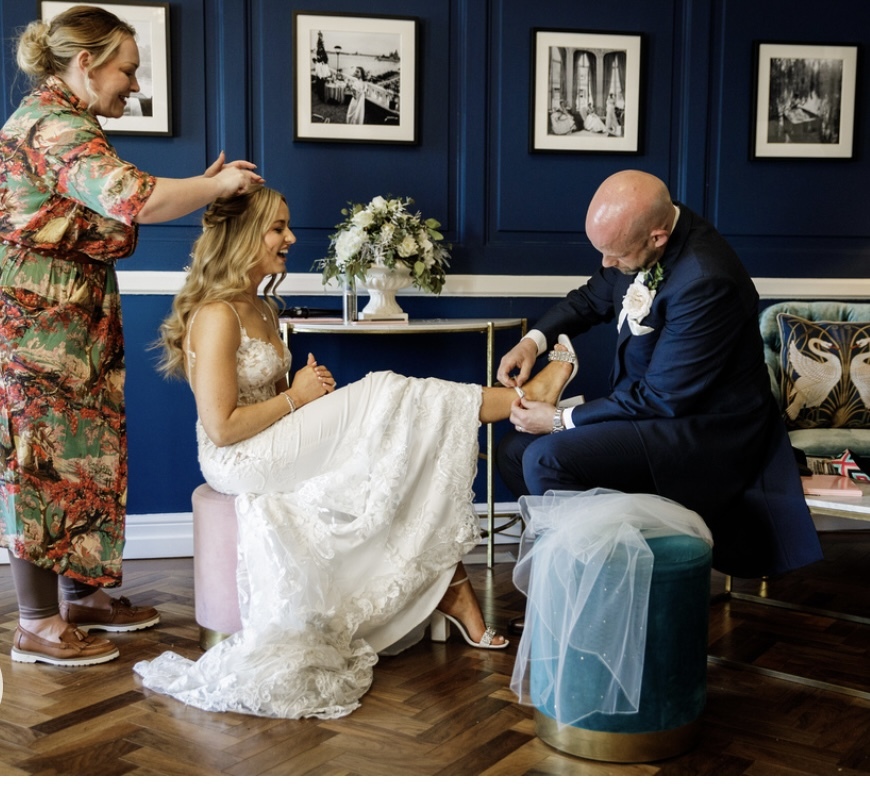 Vicky Spencer (Bridal Hair and Makeup of Cheshire) gives bride Chloe Evans a freshen up before the night do, with groom Leigh Evans.