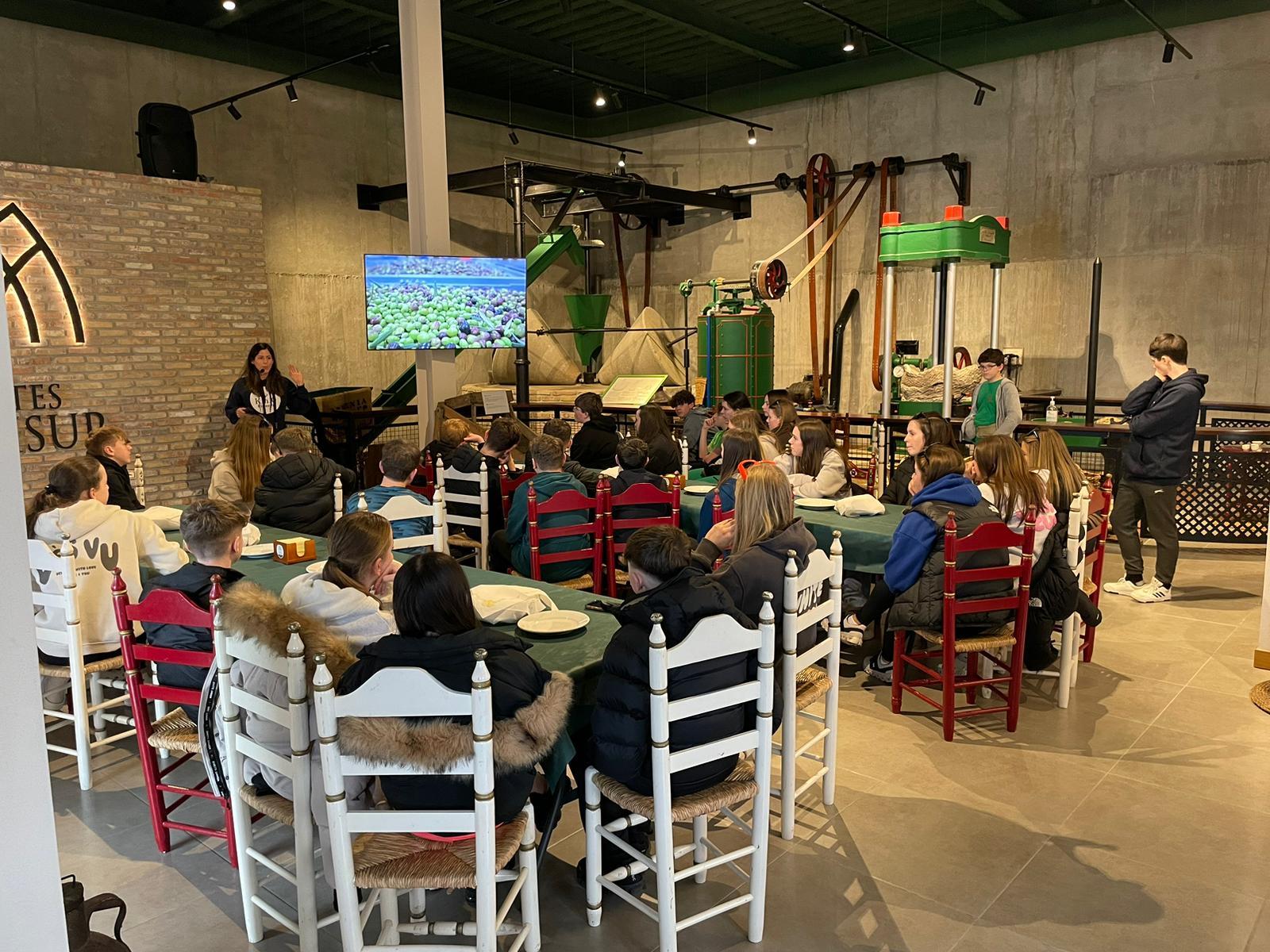 The students listen to a talk at the olive farm.