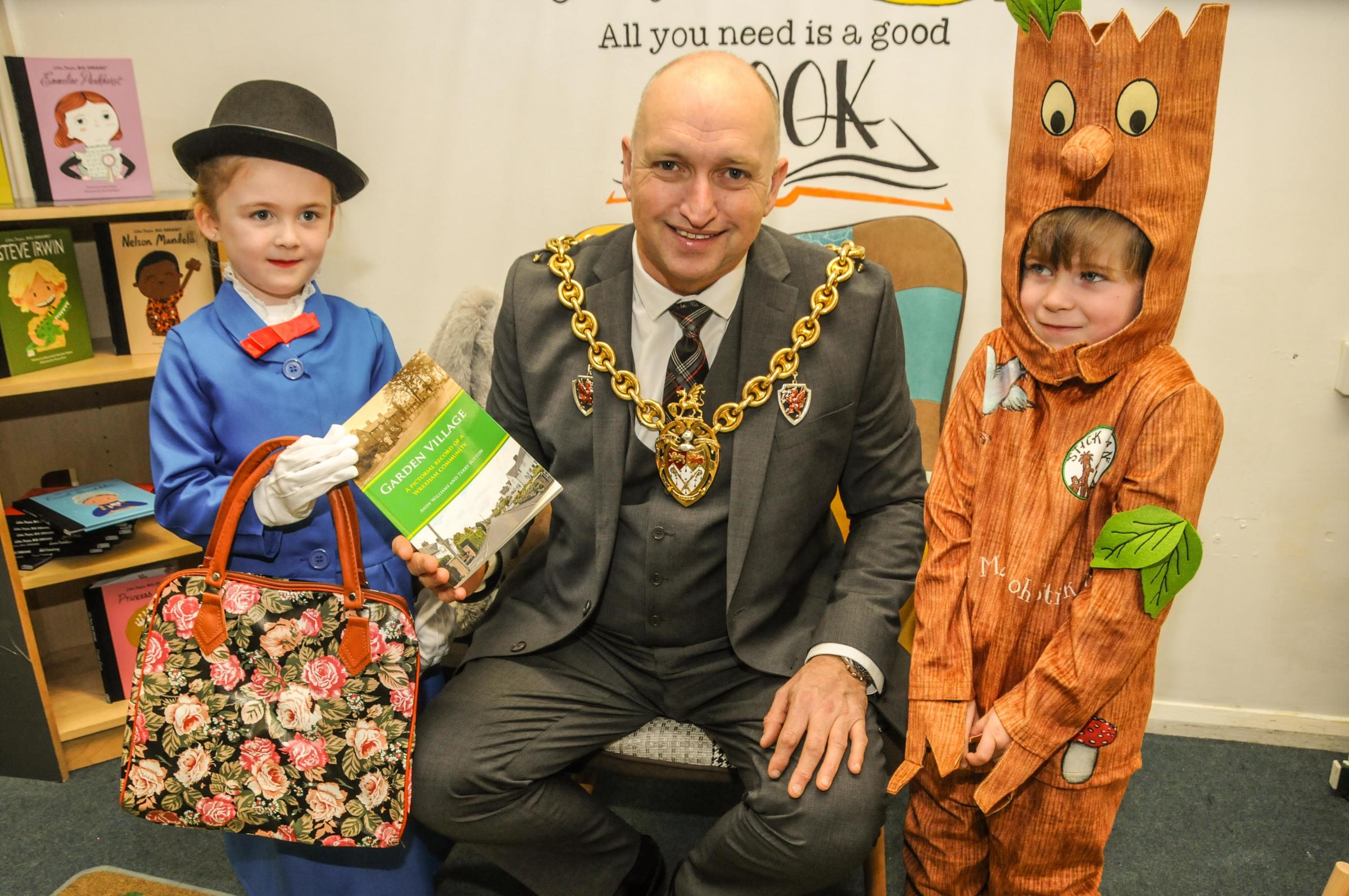 Acton Park Primary School, official opening of the library, Scarlett of Year 1, reception pupil Leo and Mayor of Wrexham Cllr Andy Williams with his book, Garden Village.