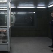 James Bond (Daniel Craig) visits Blofeld (Christoph Waltz) in his prison cell in NO TIME TO DIE. Credit: Nicola Dove