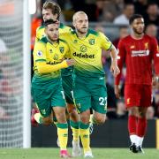 Norwich City's Teemu Pukki (right) celebrates scoring his side's first goal of the game during the Premier League match at Anfield, Liverpool..
