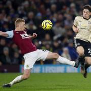 Burnley's Ben Mee (left) and Manchester United's Daniel James battle for the ball during the Premier League match at Turf Moor, Burnley..