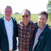 Brook Cottage Shepherd Hutt owners Mark Barrow and Jonathan Gooders with Alan Carr.