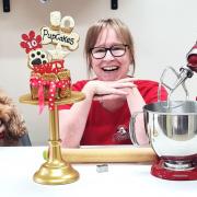 Owner of PupCakes Dog Bakery, Sharon Parry, celebrates the business' 10th anniversary with her own dog Bobbi.