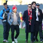 Wrexham owner Rob McElhenney (centre right) and actor Charlie Day before the Vanarama National League match at The Racecourse Ground, Wrexham. Picture date: Tuesday April 18, 2023.