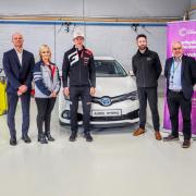 EV lecturer Charles Jones with Natalie Morris, senior specialist at Toyota, handing over the keys to an EV vehicle donated by the manufacturer during an event attended by World Rally Racing driver Elfyn Evans, Jason Stanley, general manager of Toyota GB