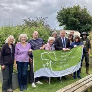 (2)	(from left to right): Moira Taylor, Jane Robertson, Matthew Hughes, Anne Davies, Jac Kearsley, Simon Baynes MP, Stacey Deere, Ian Williams, Moira Matthias, and Mike Taylor in the Plas Pentwyn Community Garden.