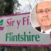 A Flintshire Council sign and, inset, Cllr Ian Roberts