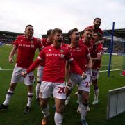 Wrexham's Tom O'Connor (no.22) celebrates scoring their side's first goal of the game with team-mates during the Emirates FA Cup Third Round match at The Croud Meadow, Shrewsbury. Picture date: Sunday January 7, 2024.