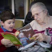 Harri Shone, who visits Pendine Park after school to read stories residents, is pictured with Betty Newcombe. Photo: Mandy Jones