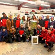The Walkabout Women present a print of The Gully to members of the Aberglaslyn Mountain Rescue Team.